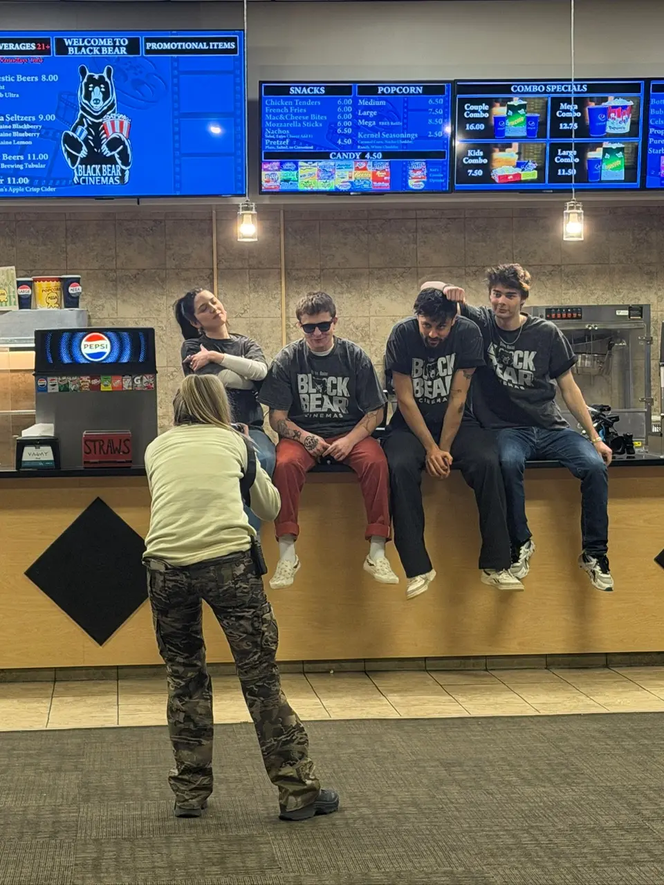 The cast of Saving Black Bear sits on the counter and poses for a photo.